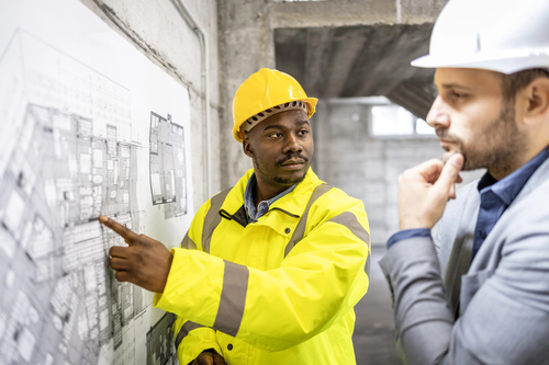 Root Cause Analysis - image of workers on a construction site investigating an incident with a site map