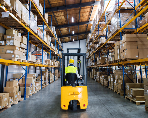ISO 45001 - image of worker driving a forklift truck in a storage area